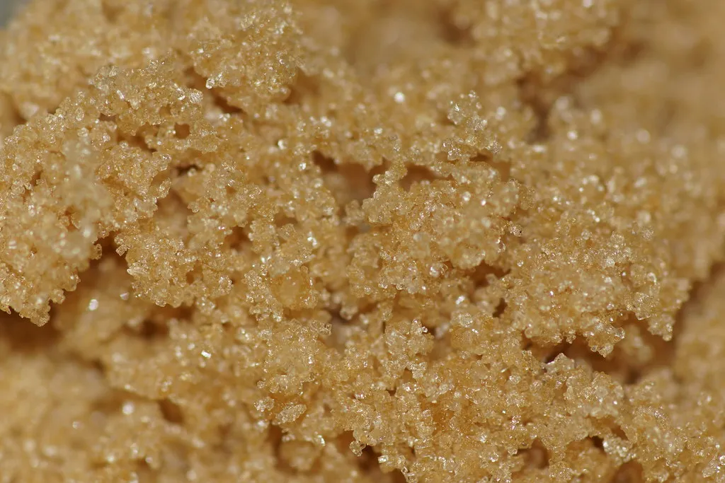 Close view of moist golden-brown sugar crystals